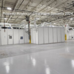 5000 square foot cleanroom, white modular walls, inside large warehouse, side view